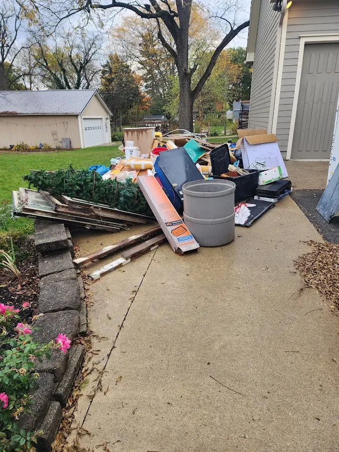 Dumpster being loaded with debris for 12 Yard Dumpster Rental in Urbana